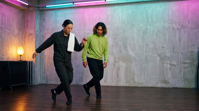 Choreographer marking a step at half speed for a dancer