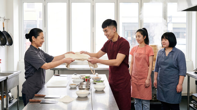 Asian cooking teacher guide student in professional kitchen