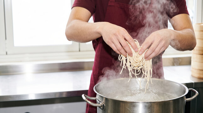 Teacher cook noodle in steaming pot at kitchen