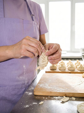 Asian teacher shape dumpling during cooking class