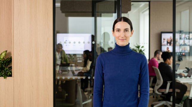 Confident female leader in a modern collaborative office