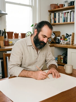 Freelance designer sketching creative work in home studio
