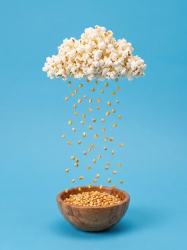 Levitating popcorn cloud above kernel-filled wooden bowl