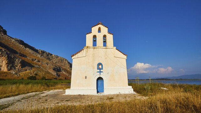 Agiou Petrou Chapel, Chapel of St Peter, Lonely church under a bright blue sky, surrounded by dry grass, Strofilia biotope, wetlands, Kalogria, Peloponnese, Greece