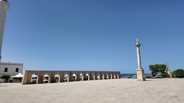 4K video of the square in Santa Maria di Leuca, featuring its majestic arches and the imposing lighthouse that overlooks the sea and the meeting point of the Adriatic and Ionian Seas. 