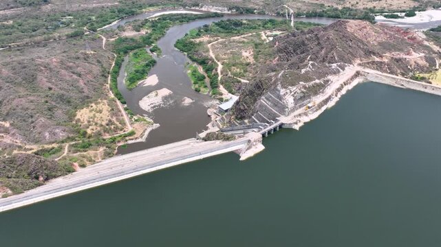 El Quimbo Dam Engineering and Hydroelectric Energy Infrastructure on the Magdalena River in Colombia. Establishing Shot. Aerial View.