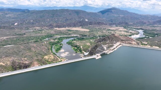 El Quimbo Dam Engineering and Hydroelectric Energy Infrastructure on the Magdalena River in Colombia. Establishing Shot. Aerial View.