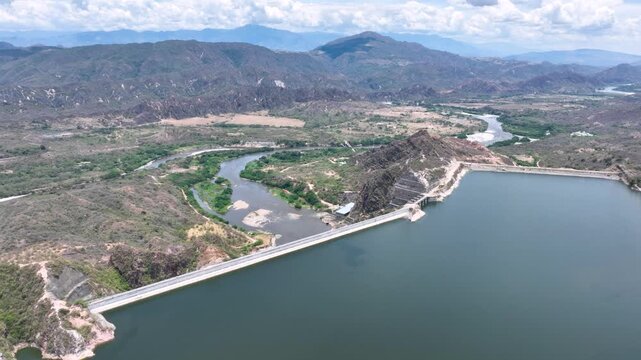 El Quimbo Dam Engineering and Hydroelectric Energy Infrastructure on the Magdalena River in Colombia. Establishing Shot. Aerial View.