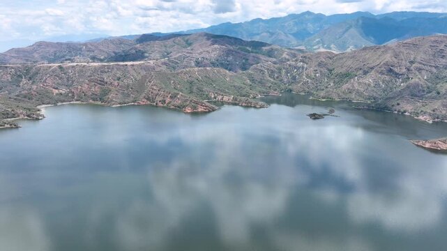 Expansive El Quimbo Hydroelectric Reservoir and Mountain Landscape in Huila, Colombia. Establishing Shot. Aerial View.