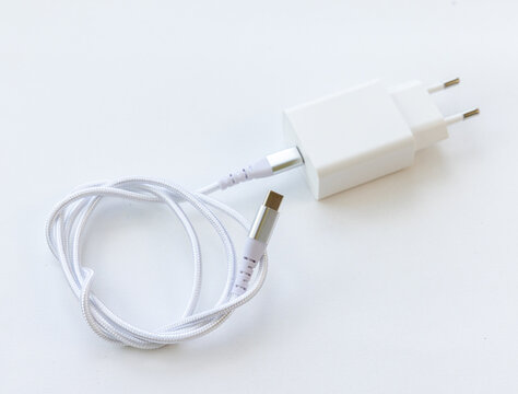 White phone charger with braided cable on surface