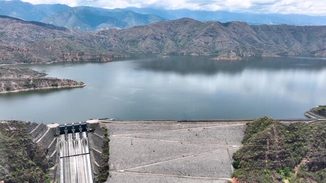 El Quimbo Reservoir Surrounded by Mountains along the Magdalena River in Huila, Colombia. Establishing Shot. Aerial View.