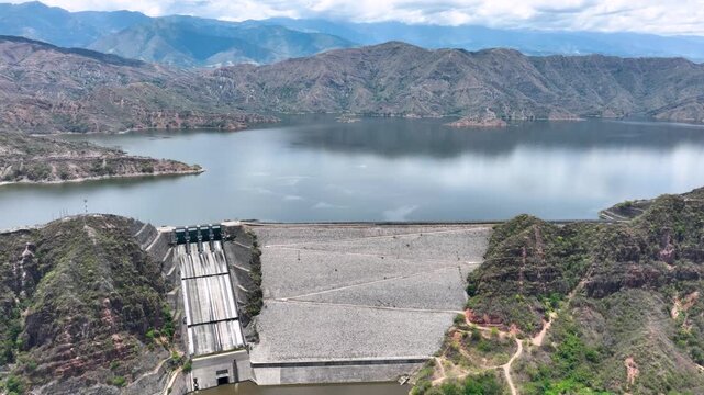 El Quimbo Dam with Hydroelectric Infrastructure and Large Reservoir on the Magdalena River, Colombia. Establishing Shot. Aerial View.