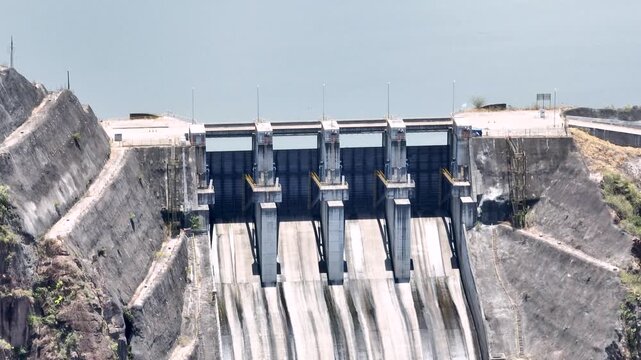 El Quimbo Dam with Hydroelectric Infrastructure and Large Reservoir on the Magdalena River, Colombia. Establishing Shot. Aerial View.