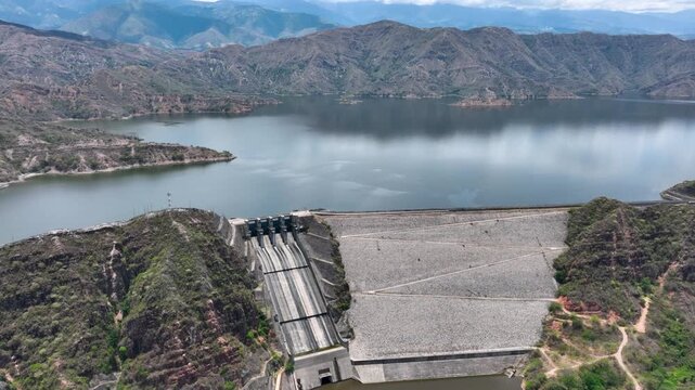 El Quimbo Dam with Hydroelectric Infrastructure and Large Reservoir on the Magdalena River, Colombia. Establishing Shot. Aerial View.