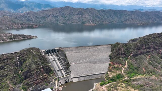 El Quimbo Dam with Hydroelectric Infrastructure and Large Reservoir on the Magdalena River, Colombia. Establishing Shot. Aerial View.