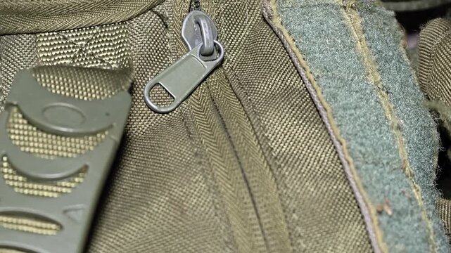A close-up shot of a zipper on a backpack, suitable for use in travel, adventure, or outdoor-themed projects