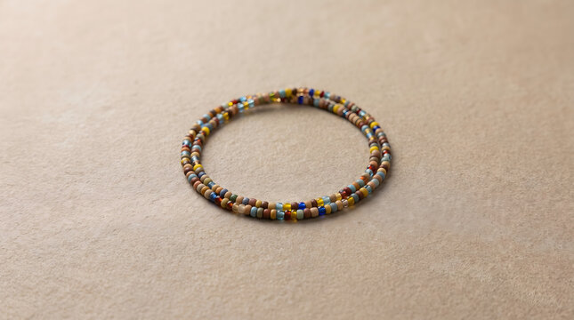 Stunning handcrafted african waist beads arranged gracefully on a neutral textured surface for commercial use
