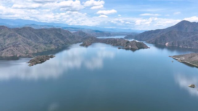 Expansive El Quimbo Hydroelectric Reservoir and Mountain Landscape in Huila, Colombia. Establishing Shot. Aerial View.