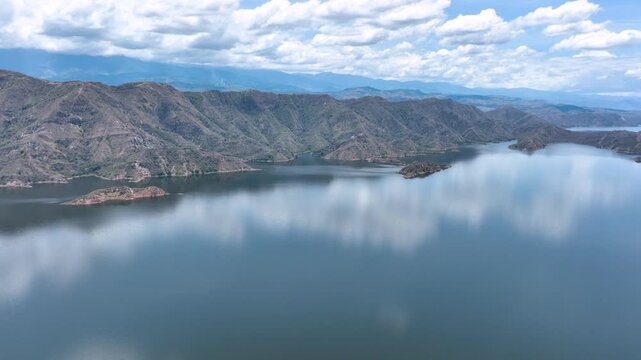 El Quimbo Reservoir Surrounded by Mountains along the Magdalena River in Huila, Colombia. Establishing Shot. Aerial View.