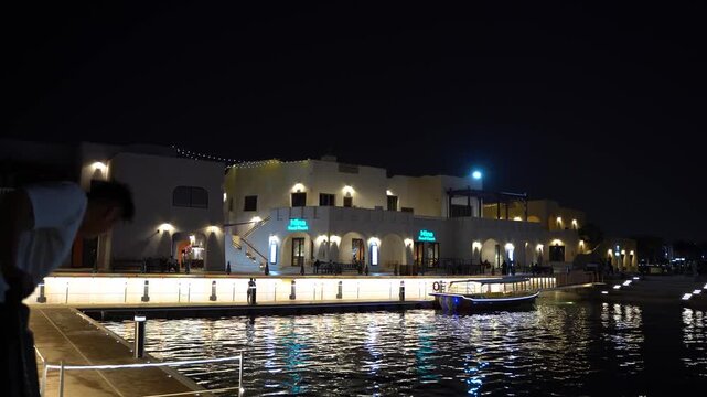 Traditional abra boat cruising down dubai creek at night