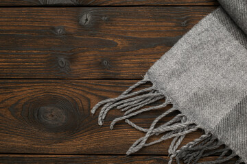 Cozy Gray Wool Blanket on Rustic Wooden Surface © kvladimirv