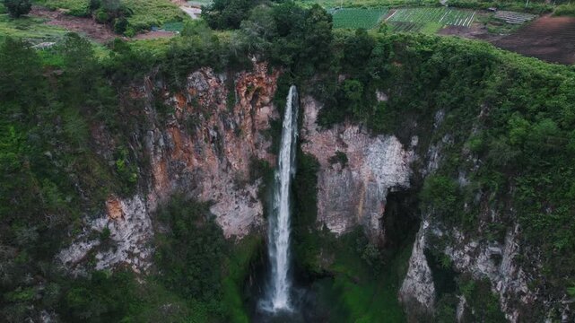 Sipiso Piso Waterfall in North Sumatra, Indonesia &ndash; Cinematic Drone Aerial View of Tropical Waterfall and Lush Mountain Landscape