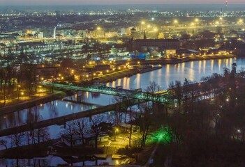 panorama opola z lotu ptaka o zmierzchu z widokiem na rzekę odrę i oświetlone mosty miejskie w polsce © Henryk Niestrój