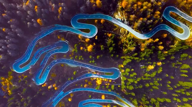 Top Down Aerial View of Winding Mountain Pass Road in Autumn Forest