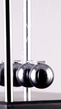 Newton's Cradle in slow motion. Vertical video.