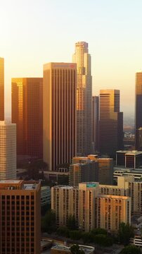 Aerial of the tall buildings of downtown Los Angeles at dawn. Vertical video.