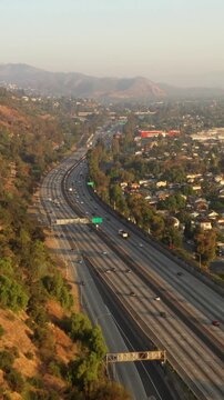 Aerial shot of the 5 freeway as it runs through the Elysian Valley in Los Angeles. Vertical video.