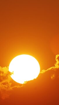 Time lapse of the sun rising behind clouds in Florida. Vertical Video.