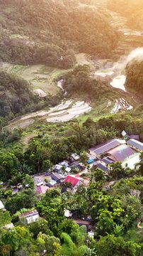 Aerial shot of the amazing terraced rice paddies in the mountains near Banaue Philippines. Vertical video.