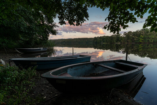 Sunset on the shore of calm lake.