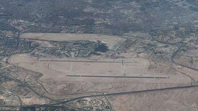 4k aerial video footage - flying along Cairo International Airport (IATA: CAI, ICAO: HECA) the main international airport serving Cairo and its metropolitan area,  with runways, taxiways and tarmac 