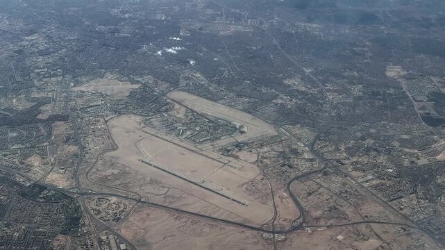 flying along Cairo International Airport (IATA: CAI, ICAO: HECA) the main international airport serving Cairo and its metropolitan area,  with runways, taxiways, aprons and infrastructure, footage