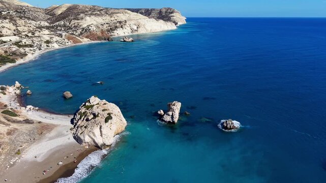 Aerial drone view of Aphrodite's Rock, Petra tou Romiou, with turquoise Mediterranean sea and rocky coastline, Paphos, Cyprus.