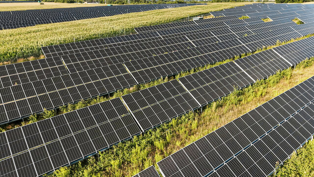 Green field with solar panels aerial view with copy space
