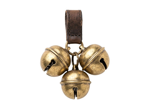 Brass sleigh bells with leather strap loop and three golden metal bells create festive holiday sounds for christmas decorations and traditional winter sleigh rides.