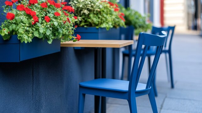 Picturesque Sidewalk Cafe Setting Showing Outdoor cafe corner with blue chairs and flower boxes street