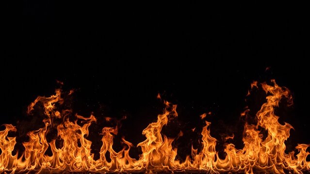 Realistic fire flames along the bottom edge on black background. Wall of orange burning flames with empty space above, fire border