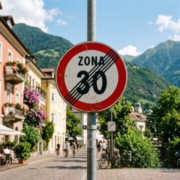 End of 30 km h Speed Limit Zone Sign in Scenic European Town with Mountains