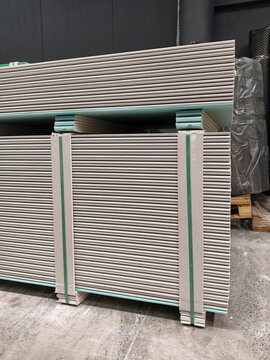 Drywall panels organized in rows for easy selection in a construction material store