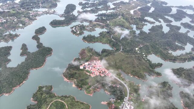 El Pe&ntilde;&oacute;n de Guatap&eacute; Rising Above Guatap&eacute; Reservoir in Antioquia, Colombia. Establishing Shot. Aerial View.