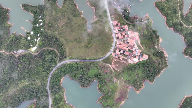 El Pe&ntilde;&oacute;n de Guatap&eacute; Rising Above Guatap&eacute; Reservoir in Antioquia, Colombia. Establishing Shot. Aerial View.