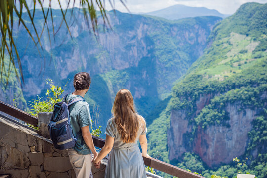 Couple travelers standing together at Sumidero Canyon viewpoint in Chiapas Mexico with steep canyon walls lush landscape river overlook nature tourism and admiring the river landscape.