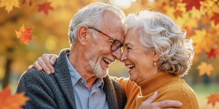 Happy older senior couple, joyful shared moment, autumn golden embracing true love, warm fall colors park. Old age faces peace Mature life story Long term touch Cozy sunset light Aging mind date years