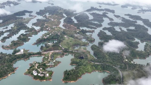 El Pe&ntilde;&oacute;n de Guatap&eacute; Rising Above Guatap&eacute; Reservoir in Antioquia, Colombia. Establishing Shot. Aerial View.