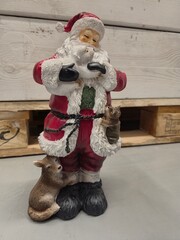 Santa Claus figurine hugging polar bear cub with woodland animals © Оксана Жемеренко