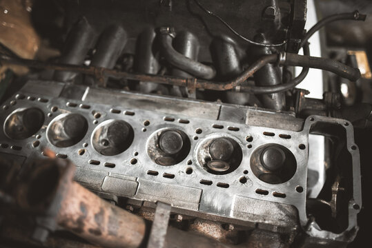 Close up view of an internal combustion engine block with exposed cylinders and metal valves